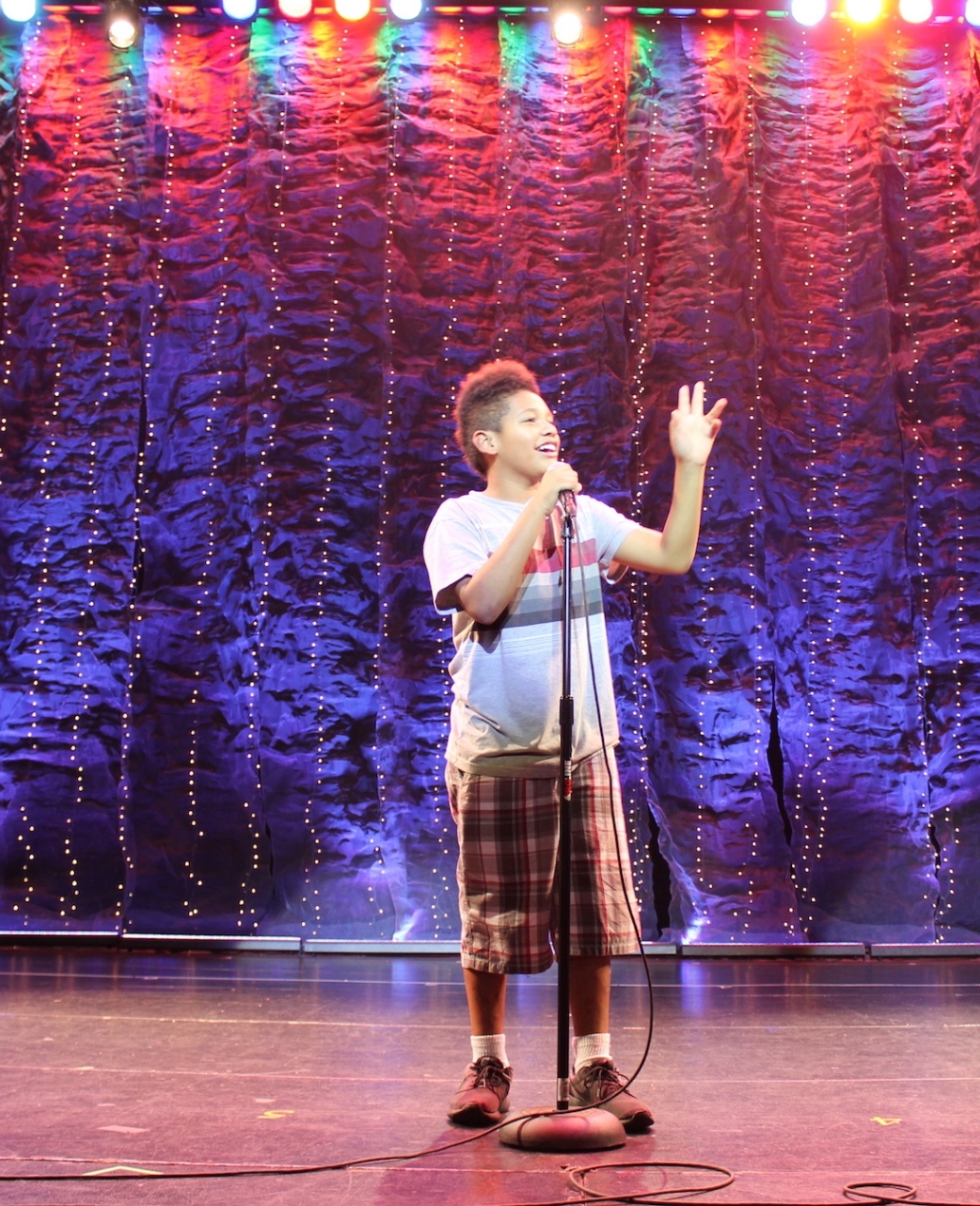 A boy performing with a microphone